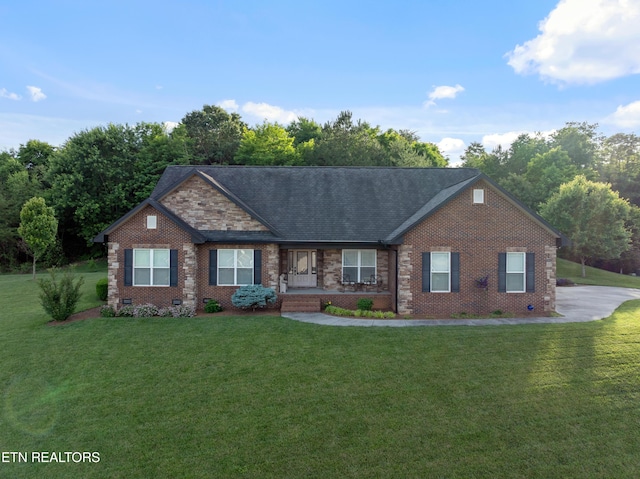 5484 Shadow Branch Ln, Corryton, TN 37721 - view of front of house with a front yard, brick siding, a porch, roof with shingles, and crawl space