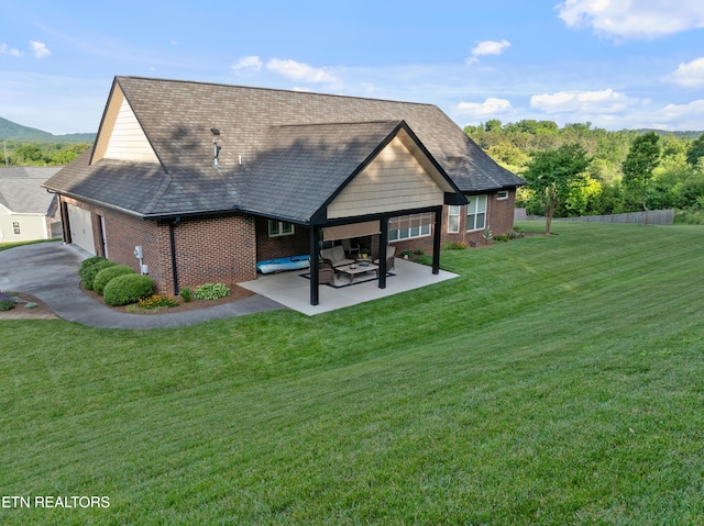 5484 Shadow Branch Ln, Corryton, TN 37721 - back of house featuring brick siding, a garage, a lawn, and a patio area