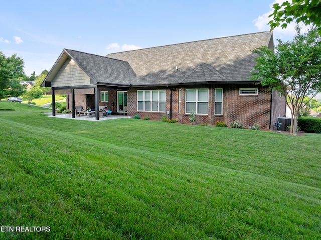 5484 Shadow Branch Ln, Corryton, TN 37721 - back of house featuring a patio area, brick siding, a lawn, and a shingled roof