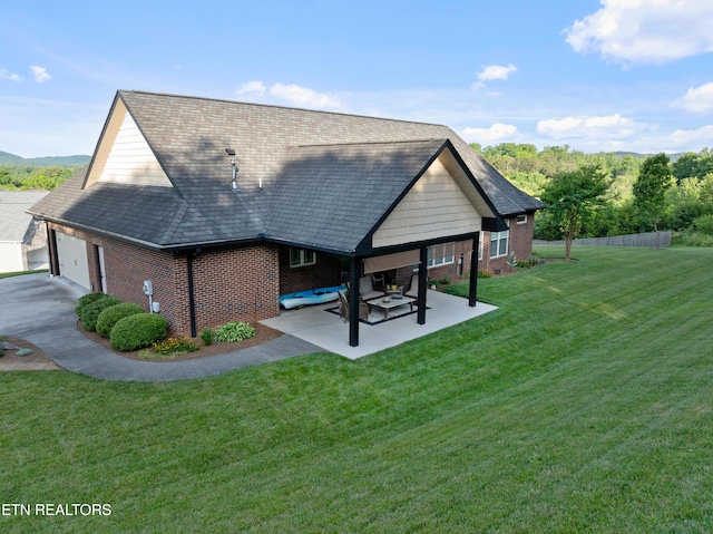 5484 Shadow Branch Ln, Corryton, TN 37721 - rear view of house with brick siding, a garage, a patio area, and roof with shingles