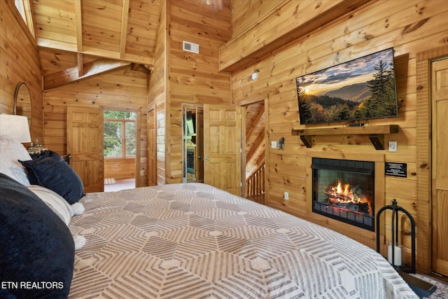 3206 Falling Leaf Way, Pigeon Forge, TN 37863 - bedroom with wood walls, a glass covered fireplace, and a towering ceiling