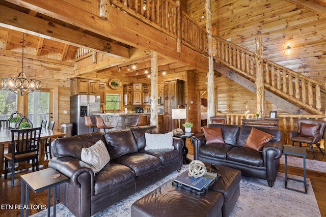 3206 Falling Leaf Way, Pigeon Forge, TN 37863 - living room with wood walls, a chandelier, wood finished floors, high vaulted ceiling, and a wood ceiling with exposed beams