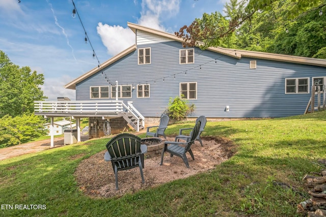 769 Gilmore Rd, Bean Station, TN 37708 - rear view of house featuring a fire pit, a wooden deck, a lawn, and stairway