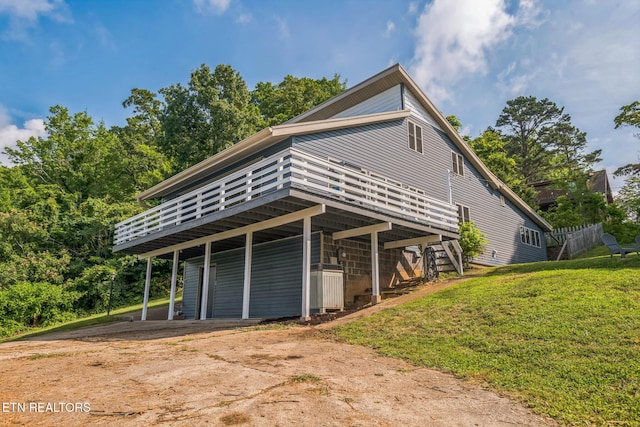 769 Gilmore Rd, Bean Station, TN 37708 - view of property exterior featuring a deck, a lawn, and driveway