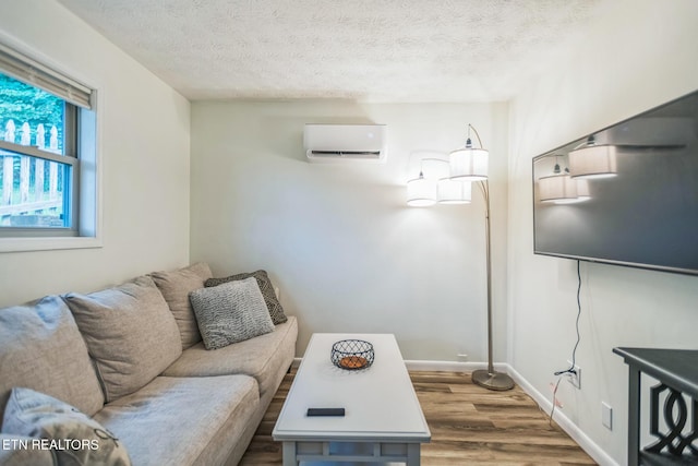 769 Gilmore Rd, Bean Station, TN 37708 - living area with an AC wall unit, wood finished floors, and a textured ceiling