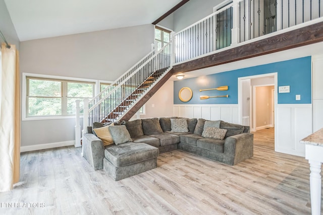 769 Gilmore Rd, Bean Station, TN 37708 - living room with high vaulted ceiling, stairway, wood finished floors, and a wainscoted wall