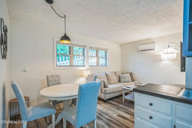 769 Gilmore Rd, Bean Station, TN 37708 - dining space with a textured ceiling, a wall unit AC, and wood finished floors
