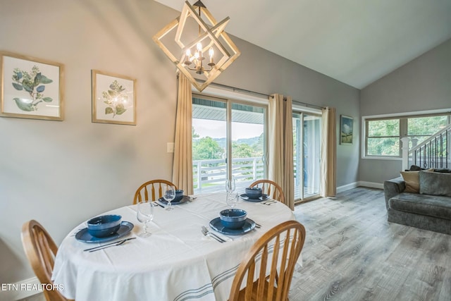 769 Gilmore Rd, Bean Station, TN 37708 - dining space with lofted ceiling, a chandelier, wood finished floors, and stairs