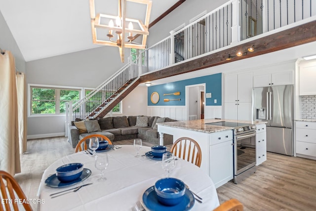 769 Gilmore Rd, Bean Station, TN 37708 - dining room with high vaulted ceiling, light wood-style flooring, stairs, and a chandelier