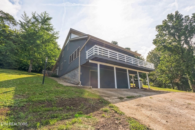 769 Gilmore Rd, Bean Station, TN 37708 - view of side of home with concrete driveway, a lawn, a wooden deck, and an attached carport