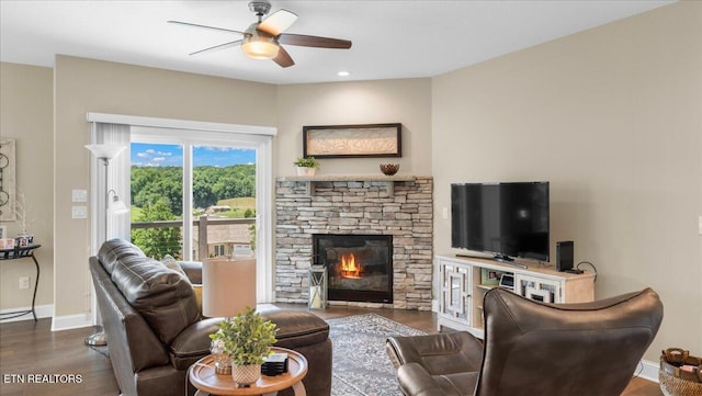 214 Unutsi Trl, Vonore, TN 37885 - living room featuring a ceiling fan, wood finished floors, a fireplace, and baseboard heating