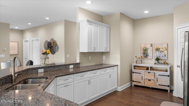214 Unutsi Trl, Vonore, TN 37885 - kitchen with dark wood-type flooring, white cabinetry, dark stone counters, recessed lighting, and refrigerator