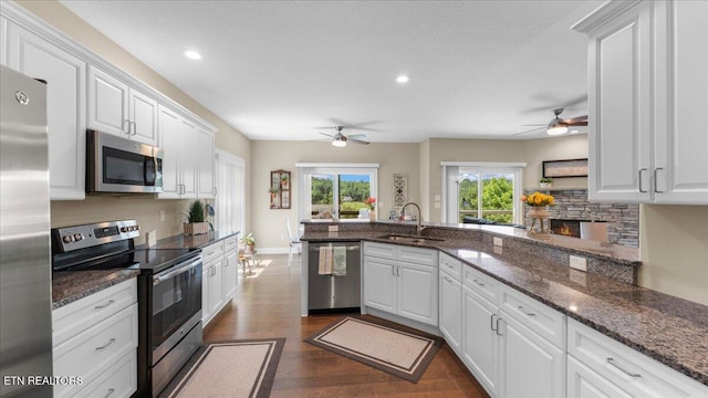 214 Unutsi Trl, Vonore, TN 37885 - kitchen featuring stainless steel appliances, ceiling fan, dark wood-type flooring, white cabinets, and recessed lighting
