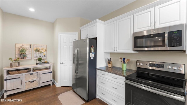 214 Unutsi Trl, Vonore, TN 37885 - kitchen with stainless steel appliances, white cabinets, dark wood-style flooring, dark stone counters, and recessed lighting