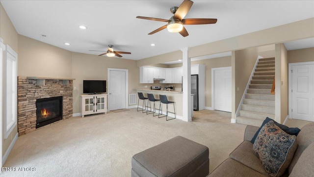 214 Unutsi Trl, Vonore, TN 37885 - living room with light colored carpet, ceiling fan, a fireplace, stairway, and recessed lighting