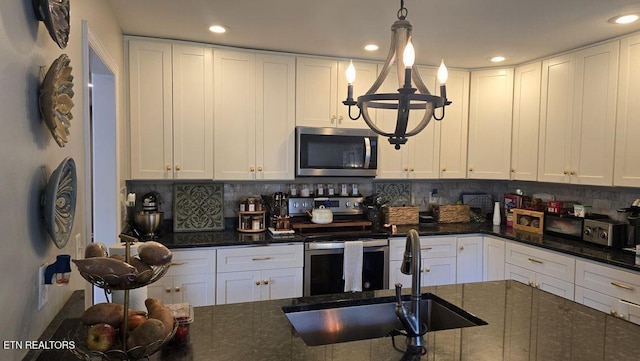 331 Hardin Rd, Dunlap, TN 37327 - kitchen featuring stainless steel appliances, recessed lighting, decorative backsplash, white cabinetry, and dark stone counters