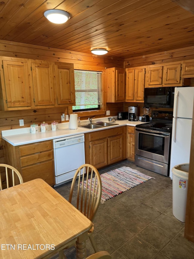 1960 Regans Ridge Way, Sevierville, TN 37876 - kitchen with white appliances, wood ceiling, light countertops, dark tile patterned flooring, and wooden walls