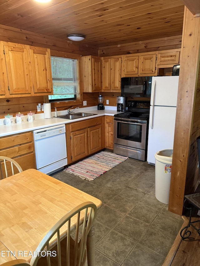 1960 Regans Ridge Way, Sevierville, TN 37876 - kitchen featuring white appliances, light countertops, wooden ceiling, and wooden walls