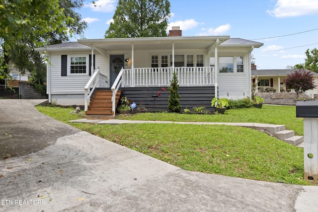 104 Ulysses Ln, Oak Ridge, TN 37830 - view of front of house with a chimney, a porch, and a front lawn