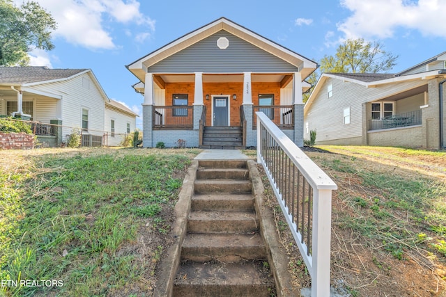2824 Linden Ave, Knoxville, TN 37914 - shotgun-style home with a porch, brick siding, and stairway