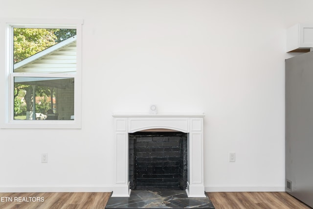 2824 Linden Ave, Knoxville, TN 37914 - detailed view of a fireplace with flush hearth, refrigerator, and wood finished floors