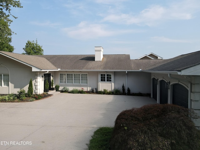 1266 Lakeview Dr, Dandridge, TN 37725 - ranch-style home featuring driveway, stucco siding, a chimney, and roof with shingles