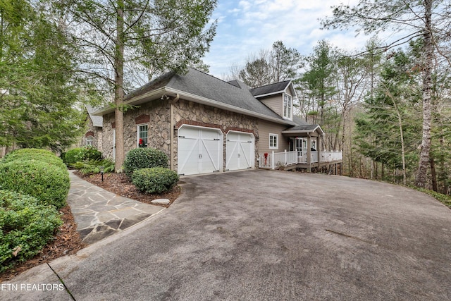 453 Mount John Loop, Townsend, TN 37882 - view of side of property with driveway, a garage, stone siding, and roof with shingles