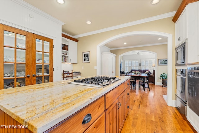 453 Mount John Loop, Townsend, TN 37882 - kitchen with stainless steel appliances, arched walkways, light wood-style floors, recessed lighting, and white cabinetry