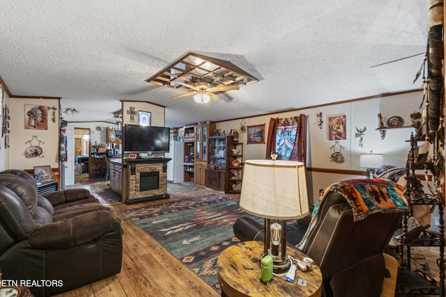 205 County Road 652, Athens, TN 37303 - living area with hardwood / wood-style floors, a textured ceiling, crown molding, a fireplace, and a ceiling fan