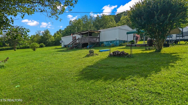 205 County Road 652, Athens, TN 37303 - view of green lawn with stairs, a deck, and a fire pit