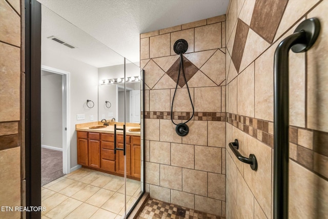 311 Meriwether Way, Pigeon Forge, TN 37863 - full bathroom featuring a tile shower, double vanity, and tile patterned flooring