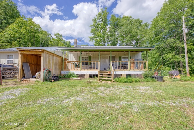 5271 Vardy Blackwater Rd, Sneedville, TN 37869 - rear view of house with a yard, covered porch, a metal roof, and a chimney