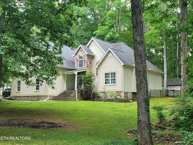 317 Fallen Oak Cir, Seymour, TN 37865 - view of front of house featuring a front lawn, stucco siding, stone siding, and a shingled roof