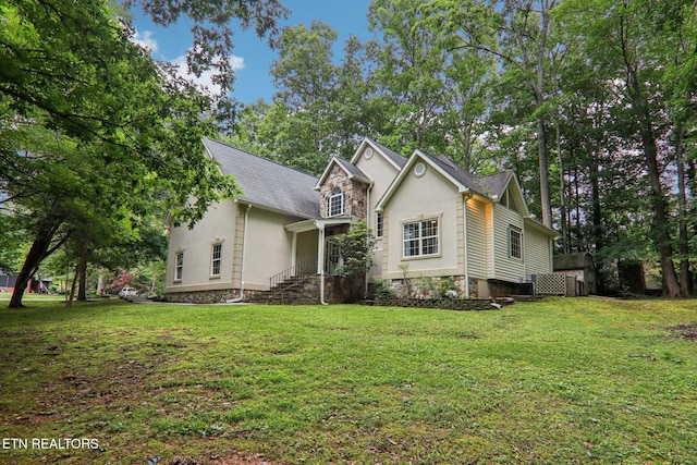 317 Fallen Oak Cir, Seymour, TN 37865 - traditional home with stucco siding, a front lawn, and a shingled roof