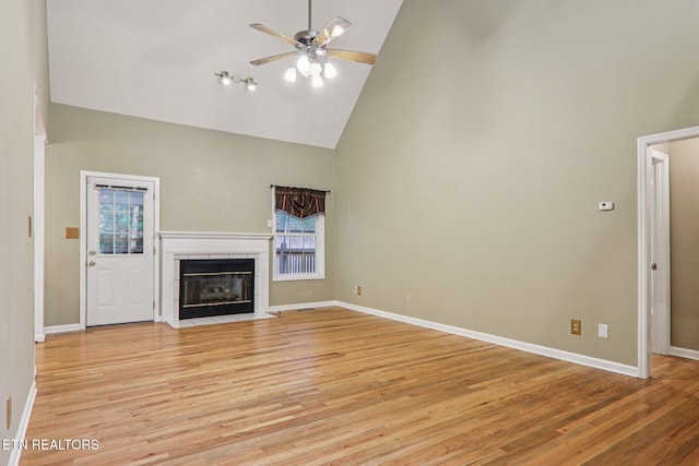 317 Fallen Oak Cir, Seymour, TN 37865 - unfurnished living room with high vaulted ceiling, a ceiling fan, light wood finished floors, and a tiled fireplace