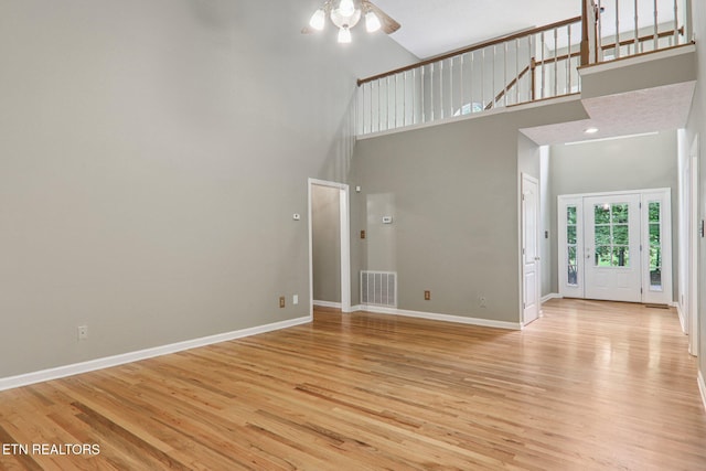 317 Fallen Oak Cir, Seymour, TN 37865 - unfurnished living room with a towering ceiling, ceiling fan, and light wood finished floors