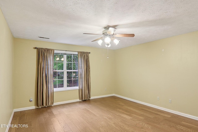317 Fallen Oak Cir, Seymour, TN 37865 - empty room featuring light wood finished floors, a ceiling fan, and a textured ceiling