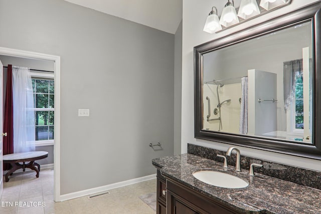 317 Fallen Oak Cir, Seymour, TN 37865 - bathroom featuring vaulted ceiling, vanity, tile patterned floors, and a shower with curtain