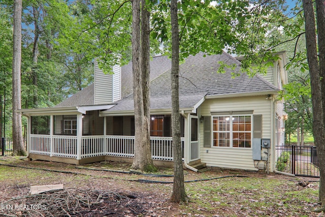 317 Fallen Oak Cir, Seymour, TN 37865 - view of front facade featuring a shingled roof, a sunroom, and a chimney