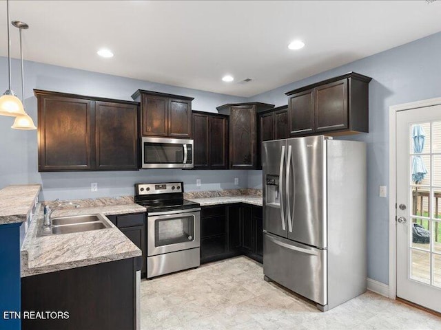 2415 Flannery Way, Powell, TN 37849 - kitchen with appliances with stainless steel finishes, dark brown cabinets, light countertops, pendant lighting, and recessed lighting