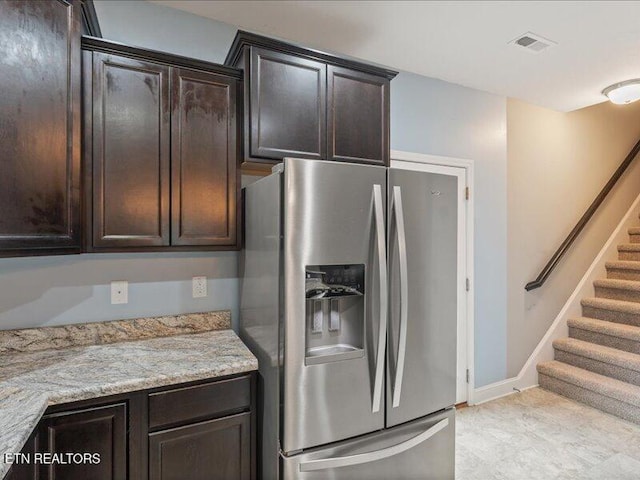 2415 Flannery Way, Powell, TN 37849 - kitchen with stainless steel fridge, dark brown cabinets, and light stone countertops
