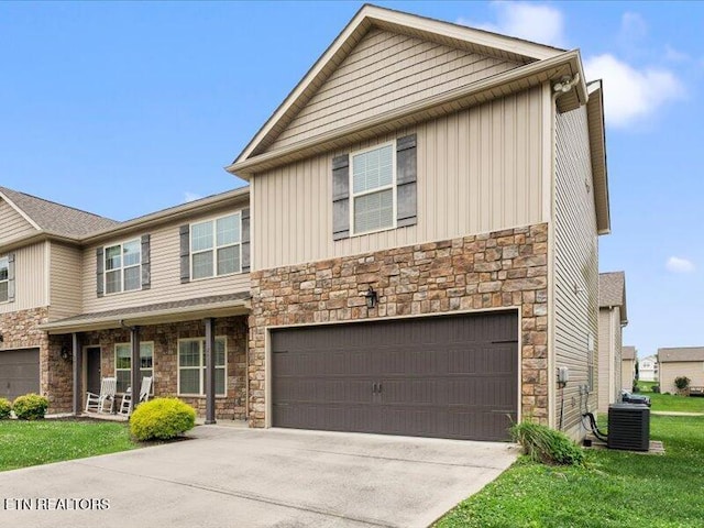 2415 Flannery Way, Powell, TN 37849 - view of front of property with stone siding, a garage, board and batten siding, and concrete driveway