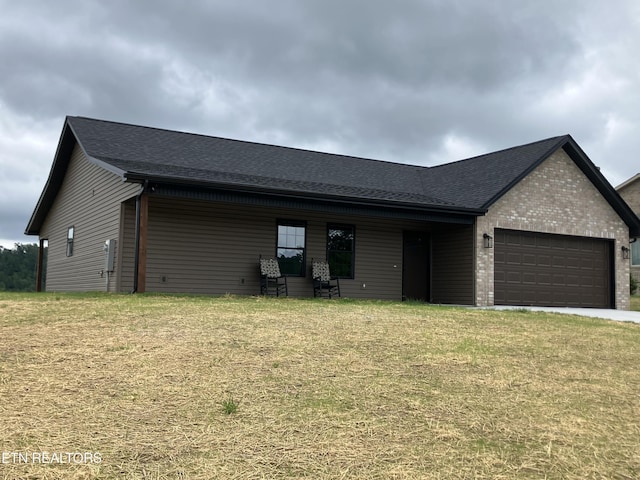 180 Sparks Landing Rd, Maynardville, TN 37807 - view of front of home with an attached garage, a front lawn, a shingled roof, and driveway