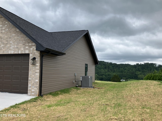 180 Sparks Landing Rd, Maynardville, TN 37807 - view of side of home with roof with shingles, brick siding, an attached garage, and a yard