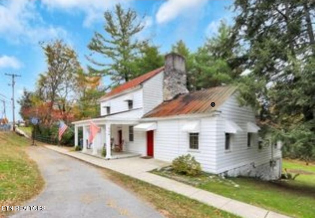 139 W Meeting St, Dandridge, TN 37725 - view of front of home with a chimney, asphalt driveway, and covered porch