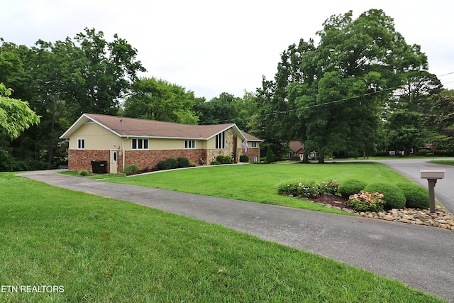 433 Clover Fork Dr, Knoxville, TN 37934 - single story home featuring brick siding, a front lawn, and view of scattered trees