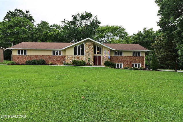 433 Clover Fork Dr, Knoxville, TN 37934 - view of front facade with a front lawn, stone siding, and view of wooded area