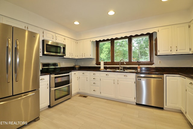 433 Clover Fork Dr, Knoxville, TN 37934 - kitchen with appliances with stainless steel finishes, dark countertops, white cabinets, and recessed lighting