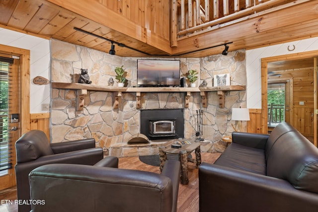3014 N Clear Fork Rd, Sevierville, TN 37862 - living room with track lighting, wood ceiling, wood walls, wood finished floors, and a wood stove