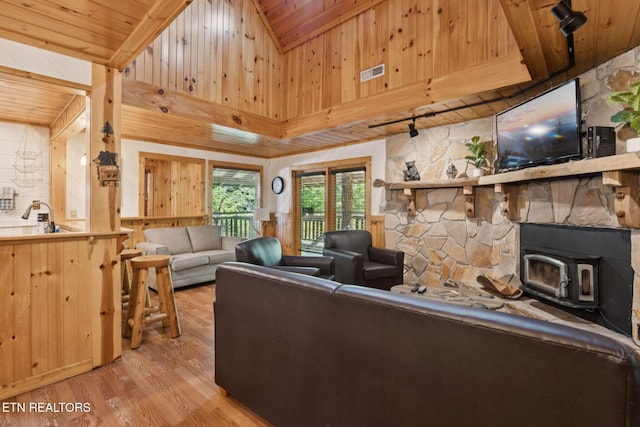 3014 N Clear Fork Rd, Sevierville, TN 37862 - living room featuring wood ceiling, light wood-type flooring, wooden walls, and a wood stove